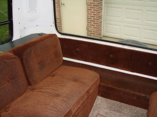 Back living area with two pull-down beds in a 23ft GMC Motorhome "Birchaven" for sale.