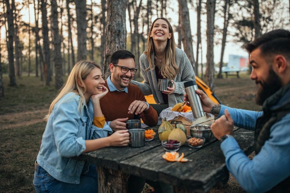 Two couples camping together in the wilderness