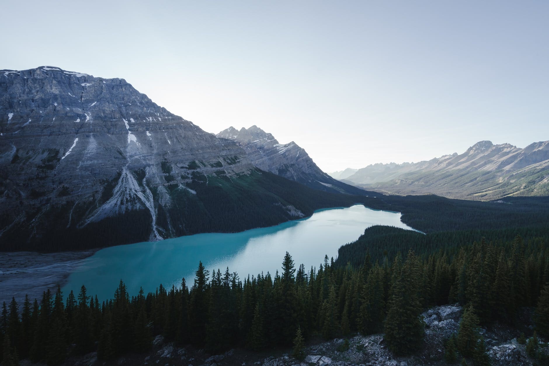 snow capped mountain next to lake under blue sky