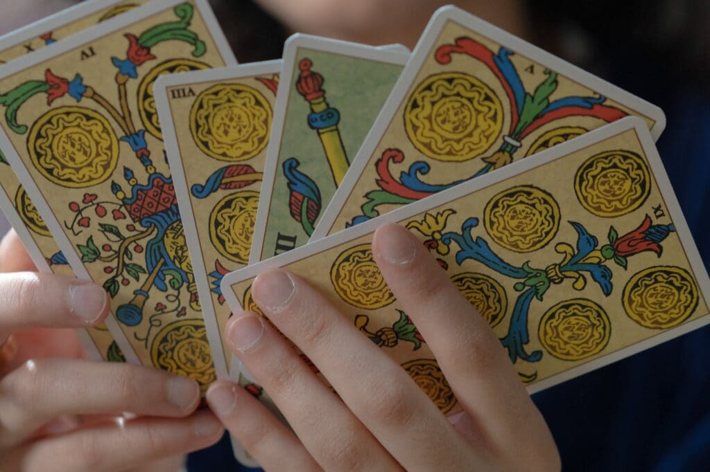 close up shot of a person holding tarot cards