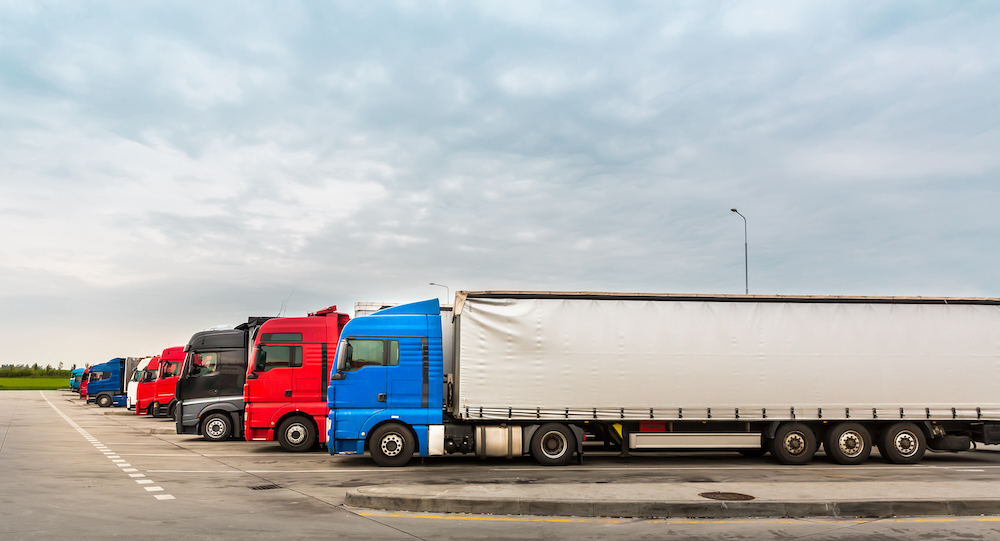 Trucks on parking, cargo transportation in European cities. Vehicles for for delivery of goods in Europe