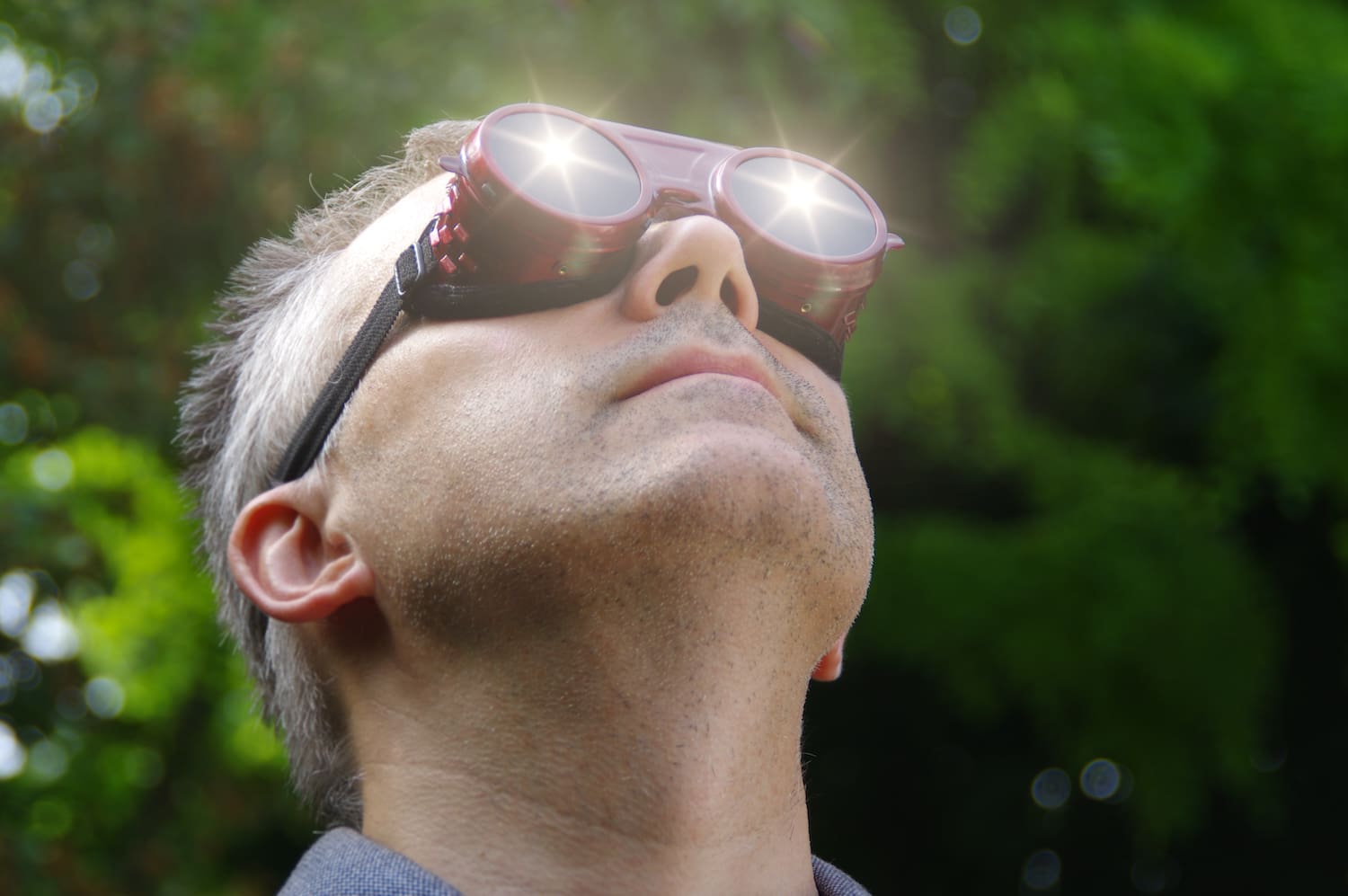 Man watching a sun eclipse through safety glasses. Looking at the solar phenomenon.